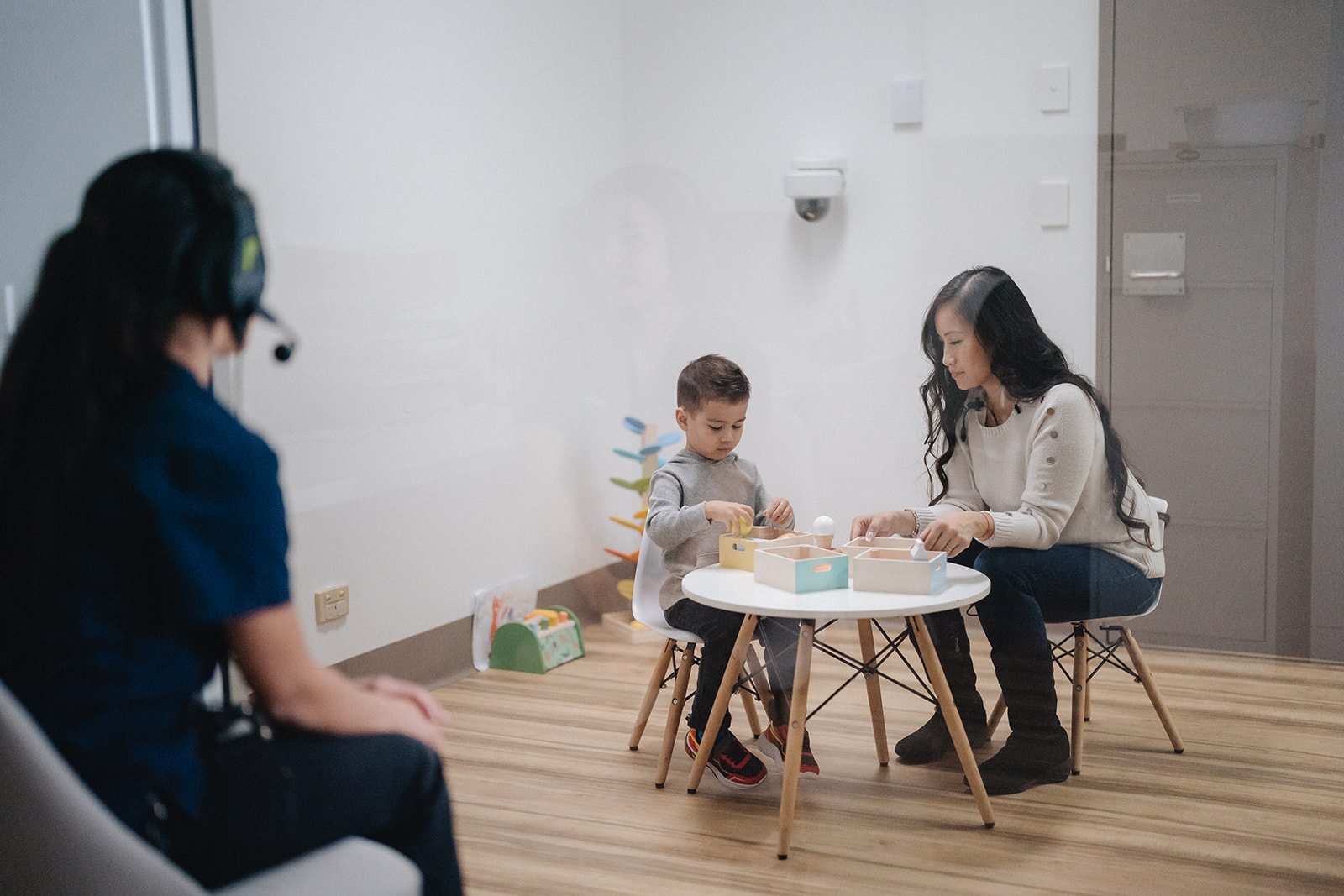 A toddler playing with blocks on a kid table at a Karitane Toddler Clinic