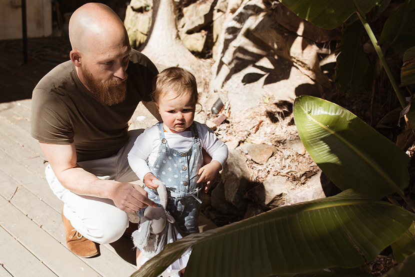 Toddler being held by its Dad